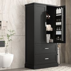 a bathroom with a black cabinet next to a toilet