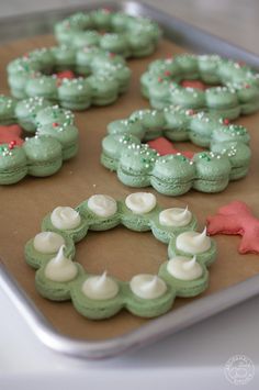 green and white decorated cookies sitting on top of a cookie sheet