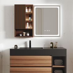 a bathroom vanity with a lighted mirror above it