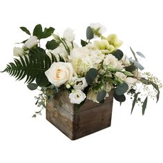 an arrangement of white flowers and greenery in a wooden box