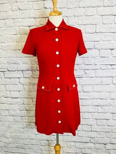 "This adorable red and white mini dress has a full button front closure with short sleeves and pockets. Super sweet white stitching on the pockets and collar. Dress is fully lined. This would be a great all around dress.  Measurements taken laying flat: Shoulders 15\" Bust 17.5\" Waist 15.5\" Hips 18.5\" Sleeve length 7.5\" Length(from shoulder to hem) 33.5\" Label Talbots Petites size 2P  Dress fits more like a size 4-6,but please refer to measurements." Retro Mini Dress With Button Closure, Fitted Short Sleeve Dress With Buttoned Pockets, Vintage Knee-length Mini Dress With Button Closure, Fitted Dress With Buttoned Pockets And Short Sleeves, Vintage Button-up Mini Dress, Classic Collared Mini Dress With Buttons, Vintage Mini Dress With Button Closure, Fitted Retro Mini Dress With Buttons, Fitted Collared Dress With Buttoned Pockets