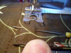 someone is stitching together with their sewing machine