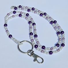 This Purple Beaded Lanyard is such a pretty and useful accessory. This lanyard measures approx. 37 inches. It is made with shades of purple and white faux pearls. It also has a swivel lobster clasp to hold your badge, employee id or keys.  This lanyard is made with 49 strand Jewelry wire for maximum durability. Check out my other lanyards here: https://www.etsy.com/ca/shop/MyGirlsFunStuff All of my items are handmade in Prince Edward Island, Canada. Shipping to Canada is by letter mail and usual Gift Beaded Chain Lanyard, Adjustable Beaded Chain Lanyard For Gift, Nurse Lanyard, Teacher Lanyard, Beaded Lanyards, Prince Edward Island, Christmas Delivery, Beaded Keychains, Mail Letters