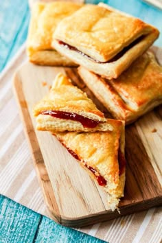 four pastries on a wooden cutting board