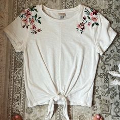 Cotton T-Shirt Emboirdered Shoulders, Spills Over To Back Tie Bottom Thick Material Nwot Size S Target White Short Sleeve T-shirt With Floral Embroidery, White Floral Embroidery Short Sleeve T-shirt, White Floral Embroidered T-shirt, White Floral Embroidered Short Sleeve T-shirt, White Embroidered T-shirt For Summer, White Crew Neck Top With Floral Embroidery, White Floral Embroidery Short Sleeve Top, White Floral Embroidered Short Sleeve Top, Cotton T-shirt With Embroidery For Spring