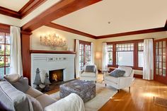 a living room with two couches and a fire place in the center of it