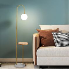 a living room scene with focus on the floor lamp and sofa in the foreground