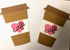 two coffee cups with hearts cut out of them