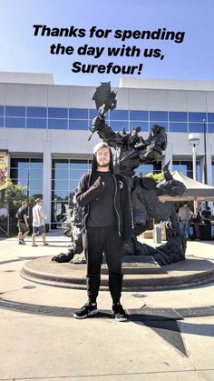 a man standing in front of a statue with the words thanks for spending the day with us, surefour