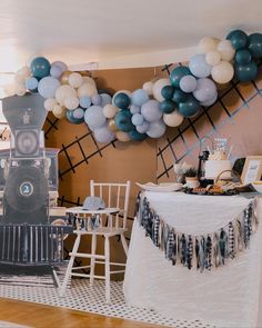 a party with balloons and decorations on the wall