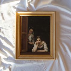 two people are looking out the window in an old fashioned painting on a white sheet