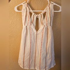 Brand New Anthropologie Flowy White Tank. Ties In Back, Colorful Threading Throughout. Size Small Petite, Fits Like Small Or Xsmall. New With Tags. Bohemian Tops With Tie Straps For Day Out, White Vacation Tops With Tie Straps, White Tops With Tie Straps For Vacation, White Tie Strap Tops For Beach, Cute V-neck Blouse For Beach, Cute White Beach Blouse, Bohemian Tie Back Top For Day Out, Bohemian Style Tie Back Top For Day Out, Cute Sleeveless Tie Back Tops