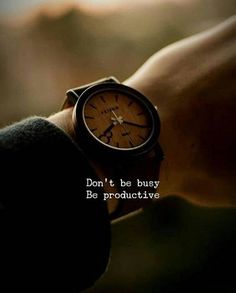 a person wearing a wrist watch with the words don't be busy be productive