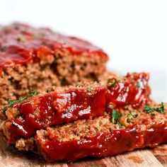 sliced meatloaf with marinara sauce and parsley on top