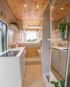 an interior view of a tiny home with wood paneling on the walls and ceiling