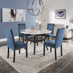 a dining room table with blue chairs around it