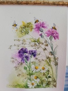 a watercolor painting of wildflowers and bees on a white paper with wood frame