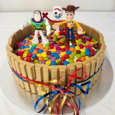 there is a cake decorated with toy story characters