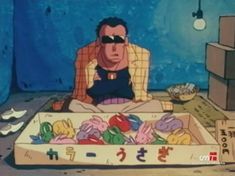 an animated man sitting in front of a box filled with food