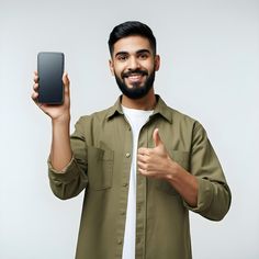 a man with a beard is holding up his cell phone and giving the thumbs up sign