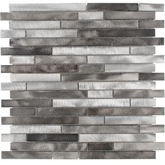 a gray and white tile wall that is made out of wood planks, with silver foil