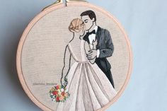 a hand embroidered picture of a bride and groom