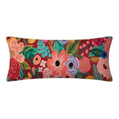 a rectangular pillow with colorful flowers and leaves on the front, along with an orange background