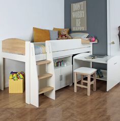 a child's bedroom with bunk beds, desk and storage space for toys on the floor