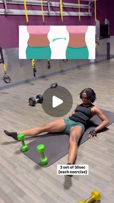 a woman laying on top of a mat in a gym