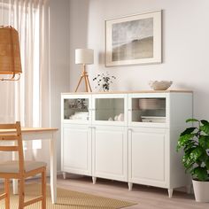 a white cabinet with glass doors in a living room