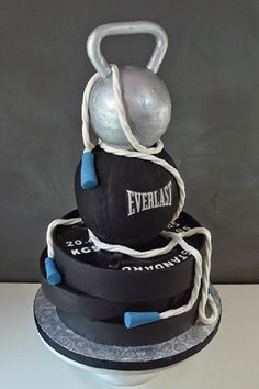 there is a cake that has a kettle on it and rope around the top of it