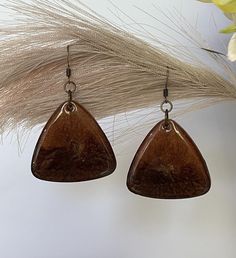 Stunning resin earrings in luscious caramel and chocolate with hits of gold hung on antiqued copper ear findings. These earrings are a statement at 2.3 inches total length and 1.5 inches wide. Earthy Brown Dangle Earrings, Vintage Copper Brown Earrings, Vintage Brown Copper Earrings, Earthy Brown Earrings With Ear Wire, Earthy Brown Drop Earrings, Earthy Brown Copper Earrings, Unique Brown Teardrop Earrings, Unique Brown Earrings For Gift, Brown Copper Drop Earrings