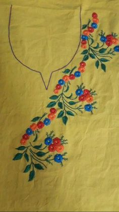 a yellow shirt with red and blue flowers on it