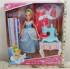 the princess doll is in its box with her dress and hair combing set on it