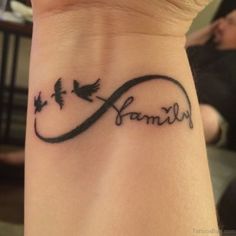 a woman's wrist tattoo with the word family written in cursive writing