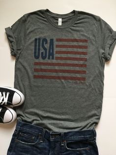 4th of July Shirt Women. USA Shirt. Patriotic Shirt. USA Tee. USA Tank. July 4th Shirt. Flag Tank Top. Stars and Stripes. July 4th Tee. You can't go wrong with this classic American flag tee. It's soft, comfortable, and has a great design. We love our unisex tees and know you will, too! This one is perfect for Memorial Day, the 4th of July, and you can wear it all year long to show your American pride! 4th of July American Flag Shirt Bella Canvas Brand Apparel Unisex fit, 4.2 oz Shirt 52% cotton Casual Tops For 4th Of July With Relaxed Fit, Casual Relaxed Fit Tops For 4th Of July, Casual Cotton Tops For 4th Of July, Short Sleeve Cotton Top With Star Print, Cotton Shirt With Star Print For Summer, Cotton Short Sleeve Tops With Star Print, Patriotic Short Sleeve T-shirt With Star Print, Casual Relaxed Fit Tops With Star Print, Patriotic Short Sleeve Top With Star Print