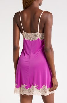 Bring an alluring style refresh to your sleepwear collection with this silky satin chemise veiled with pretty floral lace. 25 1/2" center front length (size Medium) V-neck Adjustable straps Unlined 100% polyester with 90% nylon, 10% elastane trim Machine wash, line dry Imported Silk Feminine Nightgown, Elegant Pink Camisole For Daywear, Elegant Pink Chemise For Sleep, Daywear Slip Dress With Satin Trim, Elegant Purple Fitted Sleepwear, Elegant Fitted Purple Sleepwear, Feminine Slip For Wedding Night, Feminine Wedding Night Slip, Pink Elegant Spaghetti Strap Nightgown