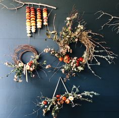 the wall is decorated with dried flowers and wreaths