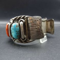 "VINTAGE WATCH CUFF BRACELET DESCRIPTION: This fabulous cuff features beautiful old specimens of turquoise and red Mediterranean coral, on a foundation of heavy gauge, hand-wrought sterling silver. This watch cuff bracelet will be a cherished addition to your collection of fine vintage Native American jewelry. MEASUREMENTS: Interior of the cuff measures 6\" with an additional 1 1/8\" non-adjustable gap. Total circumference: 7 1/8\" Measures 2 9/16\" straight across the widest part of the cuff (f Vintage Adjustable Cuff Watch, Vintage Cuff Watch, Vintage Cuff Bracelet Watch Bands, Vintage Cuff Watch Bands With Bracelet Strap, Vintage Cuff Watch Band As Gift, Vintage Patina Cuff Bracelet, Red Adjustable Vintage Cuff Bracelet, Vintage Red Adjustable Cuff Bracelet, Red Vintage Adjustable Cuff Bracelet