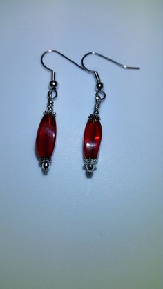 These pretty red glass bead earrings have silver accents and are hung from nickel free hooks. They make great Christmas presents for anyone on your listThese would make a beautiful addition to anyone's jewelry collection and make great gifts for friends and family! Nickel Free Red Crystal Earrings For Parties, Holiday Red Beaded Earrings With Ear Wire, Red Sterling Silver Beaded Earrings, Handmade Red Crystal Drop Earrings, Nickel-free Red Crystal Earrings, Red Nickel-free Crystal Earrings, Red Sterling Silver Beaded Earrings Gift, Red Sterling Silver Drop Crystal Earrings, Red Sterling Silver Crystal Drop Earrings