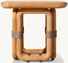 a small wooden table with two metal straps on the top and bottom, in front of a white background