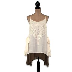 This layered dress features spaghetti straps crossed at the back and a romantic boho, mori vibe. The lace applique on the bodice and side ties also add a 20's style flapper feel to this unique loose fitting chemise. I love the creamy beige and brown combo and the high low hemline. Also available in Blue/Gray here: https://www.etsy.com/listing/656680524/romantic-clothes-layered-dress-boho-mini?ref=shop_home_active_7 Each piece in our HEART ALTERED collection has been embellished with our signatur Bohemian Dress With Lace Patchwork And Spaghetti Straps, Bohemian Spaghetti-strap Dress With Lace Patchwork, Bohemian Dress With Spaghetti Straps And Ruffles, Bohemian Spaghetti Strap Dress With Ruffles, Bohemian Spaghetti Strap Dress With Crochet Trim, Bohemian Dress With Crochet Trim And Spaghetti Straps, Bohemian Sleeveless Dress For Layering, Summer Beach Camisole With Lace Trim, Bohemian Sleeveless Boho Dress With Lace Trim