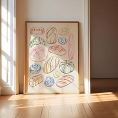 an art work is displayed on the floor in front of a window with sunlight streaming through it