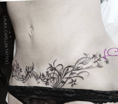 a woman's stomach with flowers and vines on it