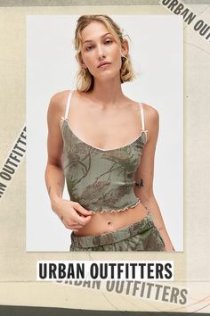 Out From Under tank top & micro short set in a camo-print pointelle knit. Features a slim & cropped fit tank and elastic waist, relaxed micro shorts. All trimmed in lace, bows and ruffle lettuce-edge trim for femme flair. Exclusively at Urban Outfitters. Features Out From Under Angie pointelle cami Pointelle knit pj set Soft & stretchy camo print pointelle knit Scoop neckline tank with spaghetti straps with bow details Elastic waist micro shorts with lettuce-edge trim Slim stretch fit Cropped length Easy pull-on style UO exclusive Content + Care Includes top and shorts 100% Cotton Machine wash Imported Size + Fit Model in Tan is 5’9" and wearing size Small Measurements taken from size Small Chest: 24" Length: 17" Waist: 26" Inseam: 2" | Out From Under Camo Printed Pointelle Cami & Micro Sh Summer Cropped Tank Top For Loungewear, Cropped Tank Top For Summer Loungewear, Summer Tank Crop Top For Loungewear, Spring Loungewear Crop Top Camisole, Casual Loungewear Crop Top Camisole, Summer Stretch Camouflage Tops, Trendy Summer Camouflage Top, Trendy Camouflage Summer Top, Trendy Camouflage Tops For Summer