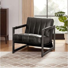 a black leather chair sitting on top of a rug