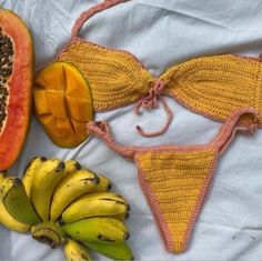 there are bananas, melon and other fruit on the bed together in this photo