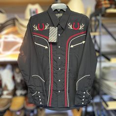 Really nice cowboy shirt to add a touch of western style. The shirt has a solid color with a nice western style embroidery. Long sleeves and a collared style with button-down closure. Made of a lightweight and breathable woven fabric blend of polyester, cotton, and cotton blend. Perfect for all seasons and occasions, including travel, weddings, parties, casual and formal events. It comes in a regular fit and size type, with adjustable features and wrinkle-resistant material. Available only in si Mexican Embroidered Shirt, Embroidered Western Shirt, Mens Dress Shirts, Cowboy Shirt, Long Sleeve Button Up Shirt, Cowboys Shirt, Mens Dress, Cow Boy, Western Shirt