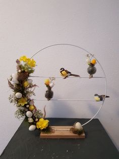 a sculpture with flowers and birds on it