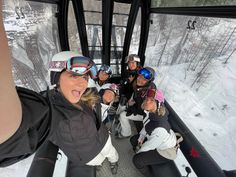 a group of people riding on top of a ski lift